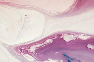 Abstract created using the technique of liquid acrylic. Macro photography of the smallest details of a panting. The panting shows how overflows of shades and colors of paint resemble space motifs. photo