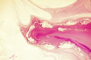 Abstract created using the technique of liquid acrylic. Macro photography of the smallest details of a panting. The panting shows how overflows of shades and colors of paint resemble space motifs. photo
