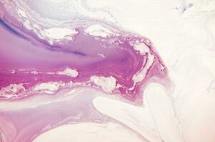 Abstract created using the technique of liquid acrylic. Macro photography of the smallest details of a panting. The panting shows how overflows of shades and colors of paint resemble space motifs. photo