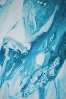 Abstract created using the technique of liquid acrylic. Macro photography of the smallest details of a picture. The picture shows how overflows of shades and colors of paint resemble space motifs. photo