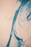 Abstract created using the technique of liquid acrylic. Macro photography of the smallest details of a picture. The picture shows how overflows of shades and colors of paint resemble space motifs. photo