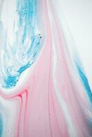Abstract created using the technique of liquid acrylic. Macro photography of the smallest details of a picture. The picture shows how overflows of shades and colors of paint resemble space motifs. photo