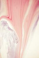 Abstract created using the technique of liquid acrylic. Macro photography of the smallest details of a picture. The picture shows how overflows of shades and colors of paint resemble space motifs. photo