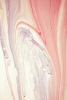 Abstract created using the technique of liquid acrylic. Macro photography of the smallest details of a picture. The picture shows how overflows of shades and colors of paint resemble space motifs. photo