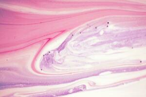 Abstract created using the technique of liquid acrylic. Macro photography of the smallest details of a picture. The picture shows how overflows of shades and colors of paint resemble space motifs. photo