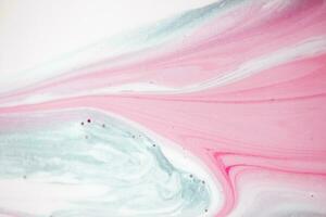 Abstract created using the technique of liquid acrylic. Macro photography of the smallest details of a picture. The picture shows how overflows of shades and colors of paint resemble space motifs. photo