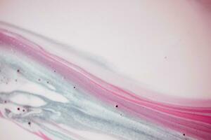 Abstract created using the technique of liquid acrylic. Macro photography of the smallest details of a picture. The picture shows how overflows of shades and colors of paint resemble space motifs. photo