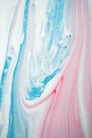 Abstract created using the technique of liquid acrylic. Macro photography of the smallest details of a picture. The picture shows how overflows of shades and colors of paint resemble space motifs. photo