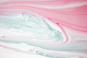 Abstract created using the technique of liquid acrylic. Macro photography of the smallest details of a picture. The picture shows how overflows of shades and colors of paint resemble space motifs. photo