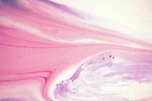 Abstract created using the technique of liquid acrylic. Macro photography of the smallest details of a picture. The picture shows how overflows of shades and colors of paint resemble space motifs. photo