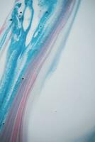Abstract created using the technique of liquid acrylic. Macro photography of the smallest details of a picture. The picture shows how overflows of shades and colors of paint resemble space motifs. photo