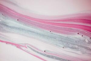 Abstract created using the technique of liquid acrylic. Macro photography of the smallest details of a picture. The picture shows how overflows of shades and colors of paint resemble space motifs. photo