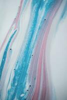 Abstract created using the technique of liquid acrylic. Macro photography of the smallest details of a picture. The picture shows how overflows of shades and colors of paint resemble space motifs. photo