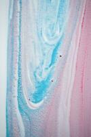 Abstract created using the technique of liquid acrylic. Macro photography of the smallest details of a picture. The picture shows how overflows of shades and colors of paint resemble space motifs. photo