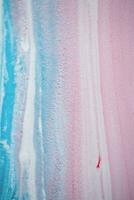 Abstract created using the technique of liquid acrylic. Macro photography of the smallest details of a picture. The picture shows how overflows of shades and colors of paint resemble space motifs. photo