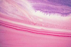 Abstract created using the technique of liquid acrylic. Macro photography of the smallest details of a picture. The picture shows how overflows of shades and colors of paint resemble space motifs. photo