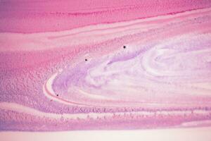 Abstract created using the technique of liquid acrylic. Macro photography of the smallest details of a picture. The picture shows how overflows of shades and colors of paint resemble space motifs. photo