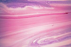 Abstract created using the technique of liquid acrylic. Macro photography of the smallest details of a picture. The picture shows how overflows of shades and colors of paint resemble space motifs. photo