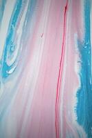 Abstract created using the technique of liquid acrylic. Macro photography of the smallest details of a picture. The picture shows how overflows of shades and colors of paint resemble space motifs. photo