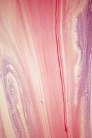 Abstract created using the technique of liquid acrylic. Macro photography of the smallest details of a picture. The picture shows how overflows of shades and colors of paint resemble space motifs. photo