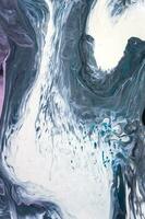 Abstract created using the technique of liquid acrylic. Macro photography of the smallest details of a picture. The picture shows how overflows of shades and colors of paint resemble space motifs. photo