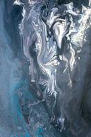 Abstract created using the technique of liquid acrylic. Macro photography of the smallest details of a picture. The picture shows how overflows of shades and colors of paint resemble space motifs. photo