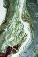 Abstract created using the technique of liquid acrylic. Macro photography of the smallest details of a picture. The picture shows how overflows of shades and colors of paint resemble space motifs. photo