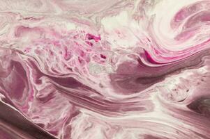 Abstract created using the technique of liquid acrylic. Macro photography of the smallest details of a picture. The picture shows how overflows of shades and colors of paint resemble space motifs. photo