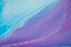 Abstract created using the technique of liquid acrylic. Macro photography of the smallest details of a panting. The panting shows how overflows of shades and colors of paint resemble space motifs. photo