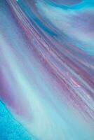 Abstract created using the technique of liquid acrylic. Macro photography of the smallest details of a panting. The panting shows how overflows of shades and colors of paint resemble space motifs. photo