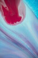 Abstract created using the technique of liquid acrylic. Macro photography of the smallest details of a panting. The panting shows how overflows of shades and colors of paint resemble space motifs. photo