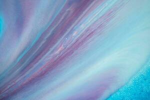 Abstract created using the technique of liquid acrylic. Macro photography of the smallest details of a panting. The panting shows how overflows of shades and colors of paint resemble space motifs. photo