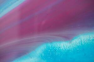 Abstract created using the technique of liquid acrylic. Macro photography of the smallest details of a panting. The panting shows how overflows of shades and colors of paint resemble space motifs. photo