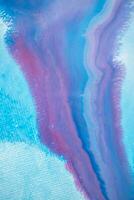 Abstract created using the technique of liquid acrylic. Macro photography of the smallest details of a panting. The panting shows how overflows of shades and colors of paint resemble space motifs. photo