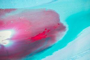 Abstract created using the technique of liquid acrylic. Macro photography of the smallest details of a panting. The panting shows how overflows of shades and colors of paint resemble space motifs. photo