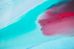 Abstract created using the technique of liquid acrylic. Macro photography of the smallest details of a panting. The panting shows how overflows of shades and colors of paint resemble space motifs. photo