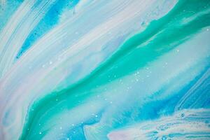 Abstract created using the technique of liquid acrylic. Macro photography of the smallest details of a panting. The panting shows how overflows of shades and colors of paint resemble space motifs. photo