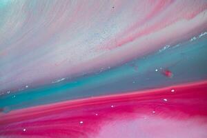 Abstract created using the technique of liquid acrylic. Macro photography of the smallest details of a panting. The panting shows how overflows of shades and colors of paint resemble space motifs. photo