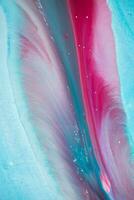 Abstract created using the technique of liquid acrylic. Macro photography of the smallest details of a panting. The panting shows how overflows of shades and colors of paint resemble space motifs. photo