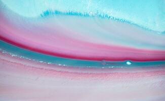 Abstract created using the technique of liquid acrylic. Macro photography of the smallest details of a panting. The panting shows how overflows of shades and colors of paint resemble space motifs. photo