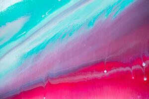 Abstract created using the technique of liquid acrylic. Macro photography of the smallest details of a panting. The panting shows how overflows of shades and colors of paint resemble space motifs. photo