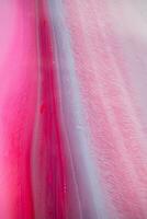 Abstract created using the technique of liquid acrylic. Macro photography of the smallest details of a panting. The panting shows how overflows of shades and colors of paint resemble space motifs. photo