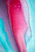 Abstract created using the technique of liquid acrylic. Macro photography of the smallest details of a panting. The panting shows how overflows of shades and colors of paint resemble space motifs. photo