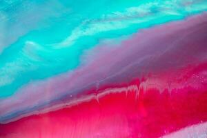 Abstract created using the technique of liquid acrylic. Macro photography of the smallest details of a panting. The panting shows how overflows of shades and colors of paint resemble space motifs. photo