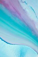 Abstract created using the technique of liquid acrylic. Macro photography of the smallest details of a panting. The panting shows how overflows of shades and colors of paint resemble space motifs. photo