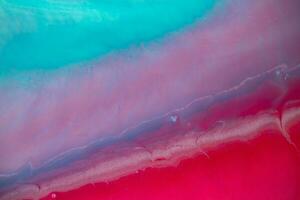 Abstract created using the technique of liquid acrylic. Macro photography of the smallest details of a panting. The panting shows how overflows of shades and colors of paint resemble space motifs. photo
