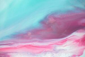 Abstract created using the technique of liquid acrylic. Macro photography of the smallest details of a panting. The panting shows how overflows of shades and colors of paint resemble space motifs. photo