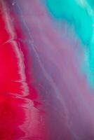 Abstract created using the technique of liquid acrylic. Macro photography of the smallest details of a panting. The panting shows how overflows of shades and colors of paint resemble space motifs. photo