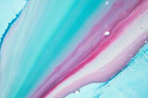Abstract created using the technique of liquid acrylic. Macro photography of the smallest details of a panting. The panting shows how overflows of shades and colors of paint resemble space motifs. photo