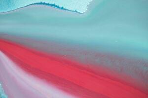 Abstract created using the technique of liquid acrylic. Macro photography of the smallest details of a panting. The panting shows how overflows of shades and colors of paint resemble space motifs. photo